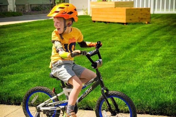 Arm Dynamics pediatric patient riding a bike