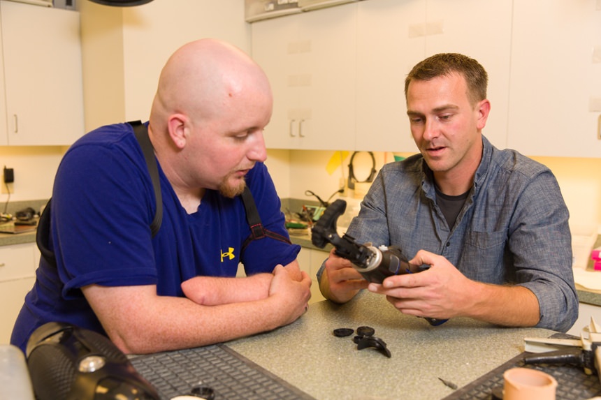Arm Dynamics technician discussing body powered prosthesis with patient