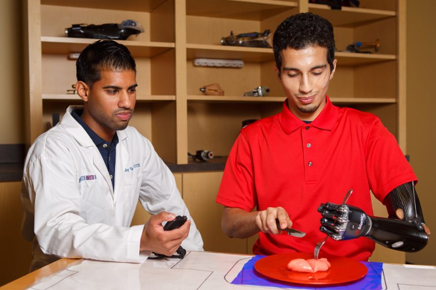 Arm Dynamics occupational therapist working with a patient wearing a Utah Arm prosthesis