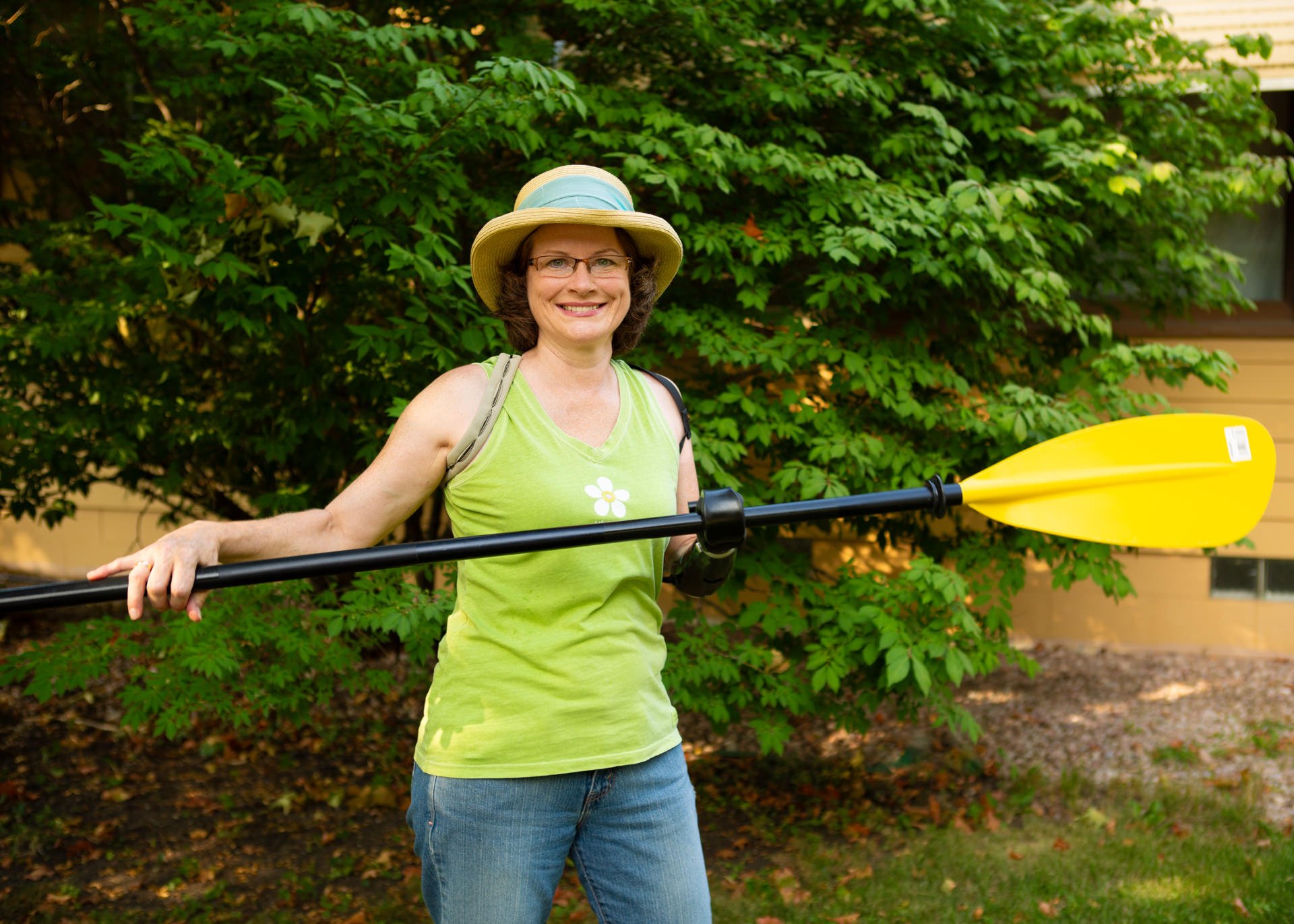 A transradial patient uses her activity-specific prosthesis for paddling a boat or canoe.