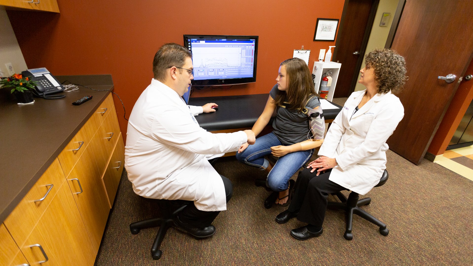 Patrick Prigge, CP, FAAOP(D) and Jennifer Peterson, MA, PT working with a TMR patient