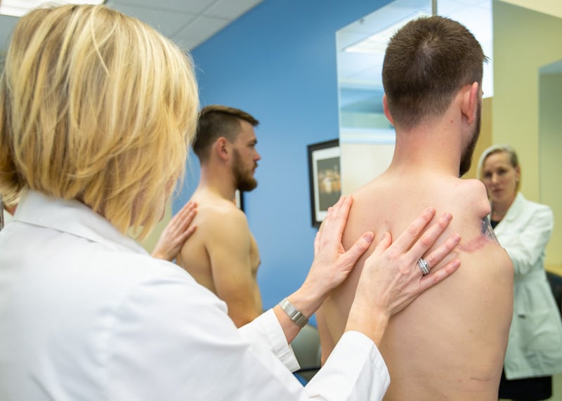Arm Dynamics Therapist at Portland center examines patient