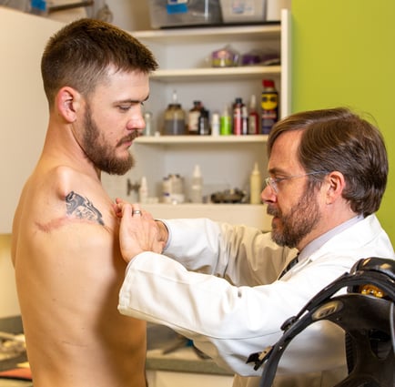 Arm Dynamics Prosthetist at Portland center examines patient