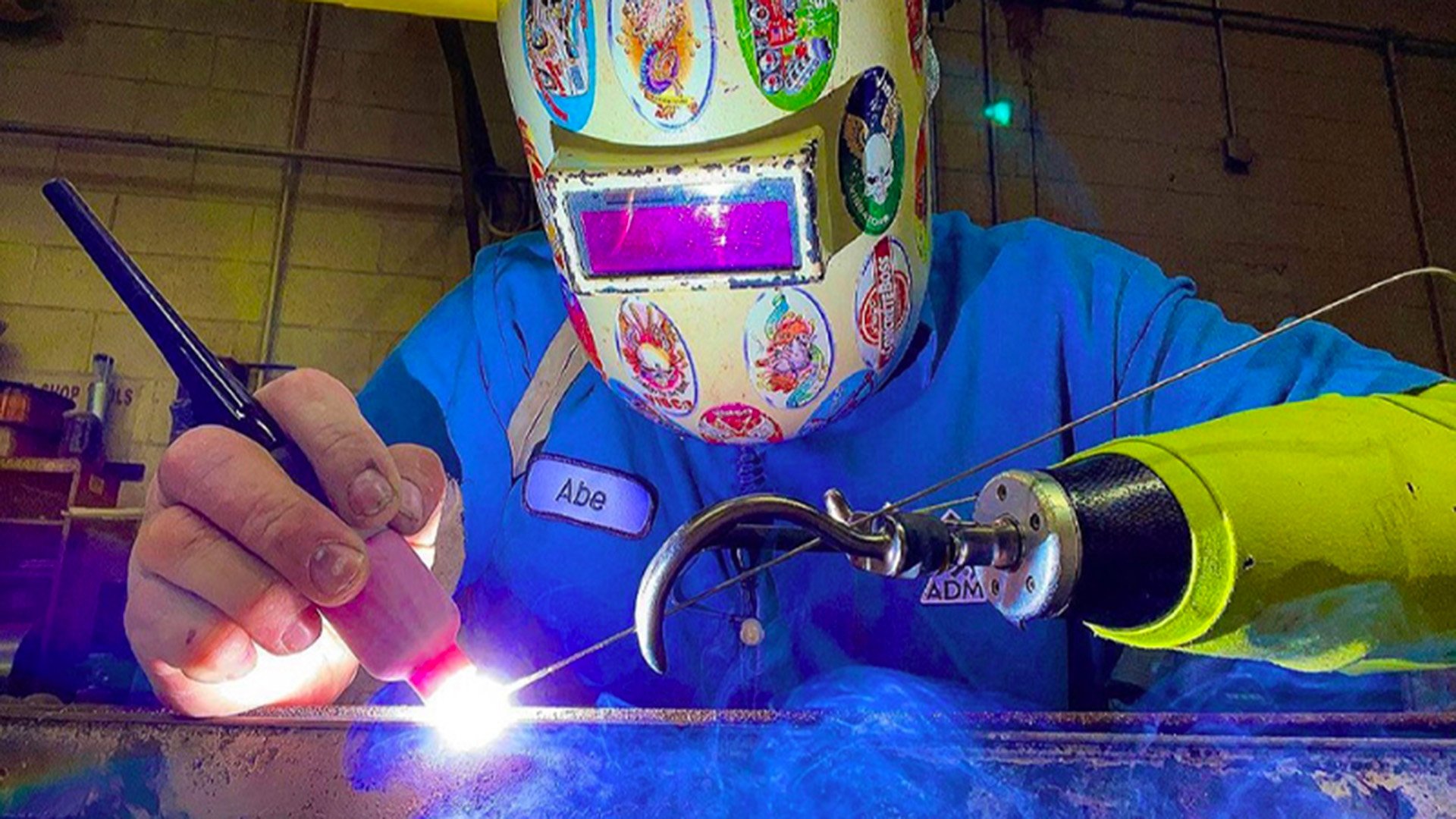 Abe uses a body-powered option for welding.