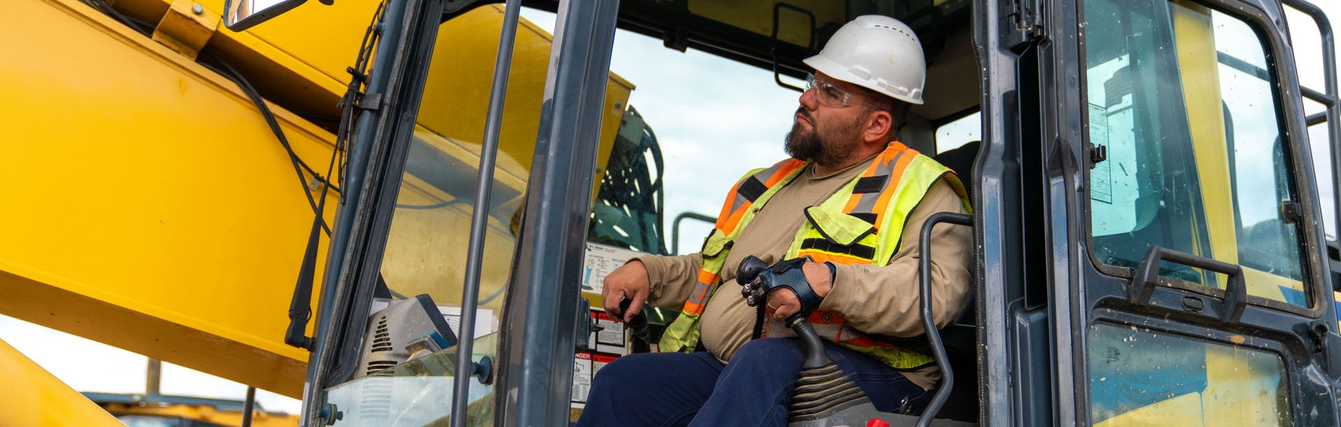 Mark Betters running construction excavator on the job with point design digits
