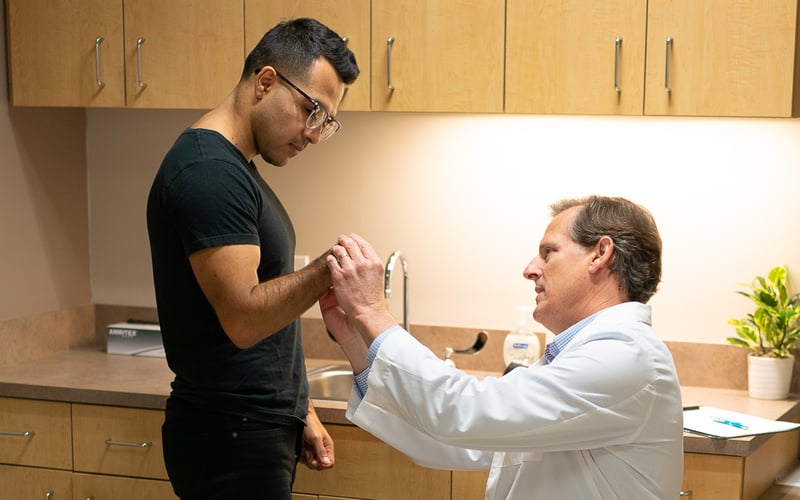 Arm Dynamics Prosthetist at Houston center examines patient