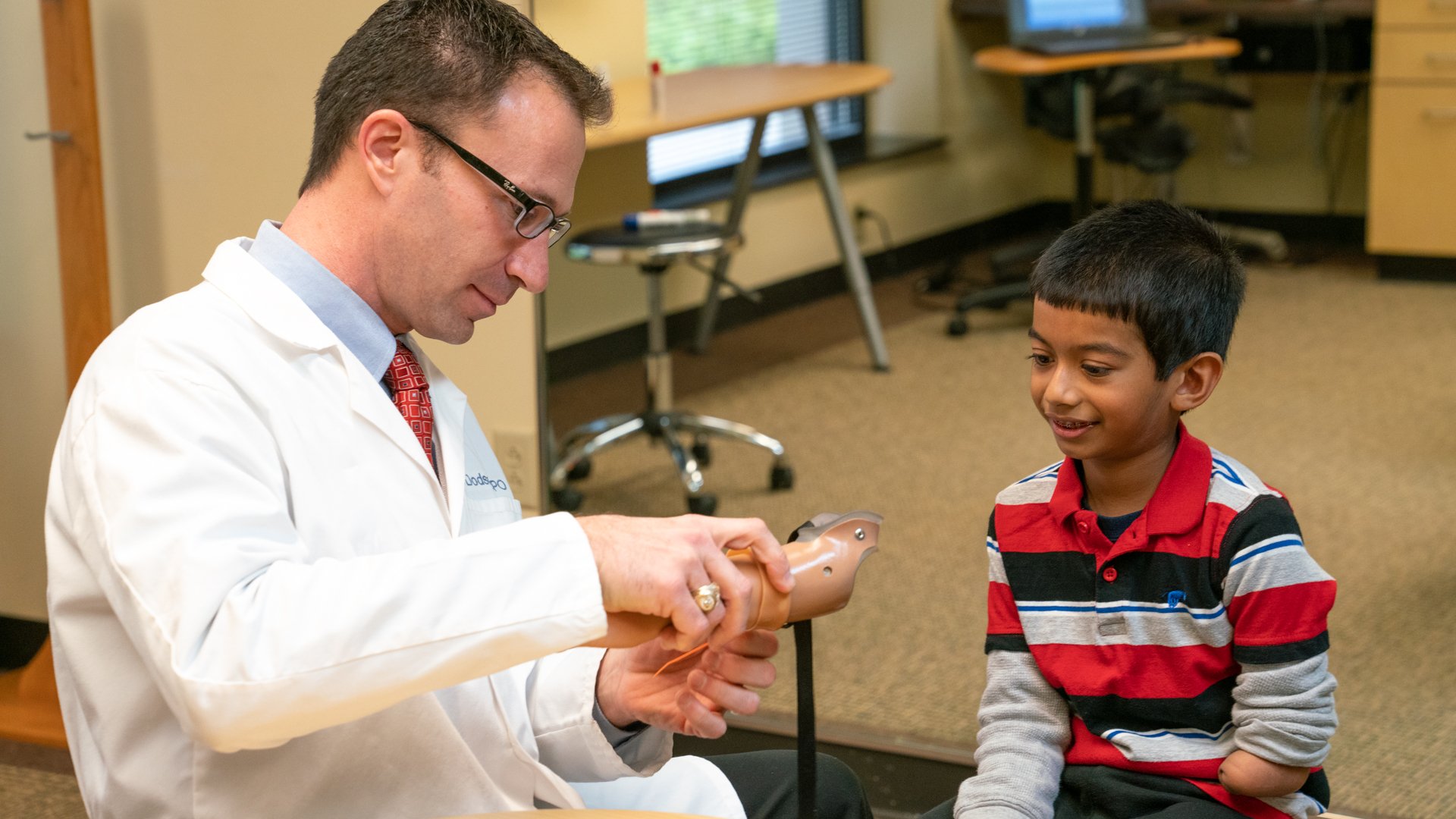 Prosthetist Rob Dodson, CPO, FAAOP, fitting a pediatric patient