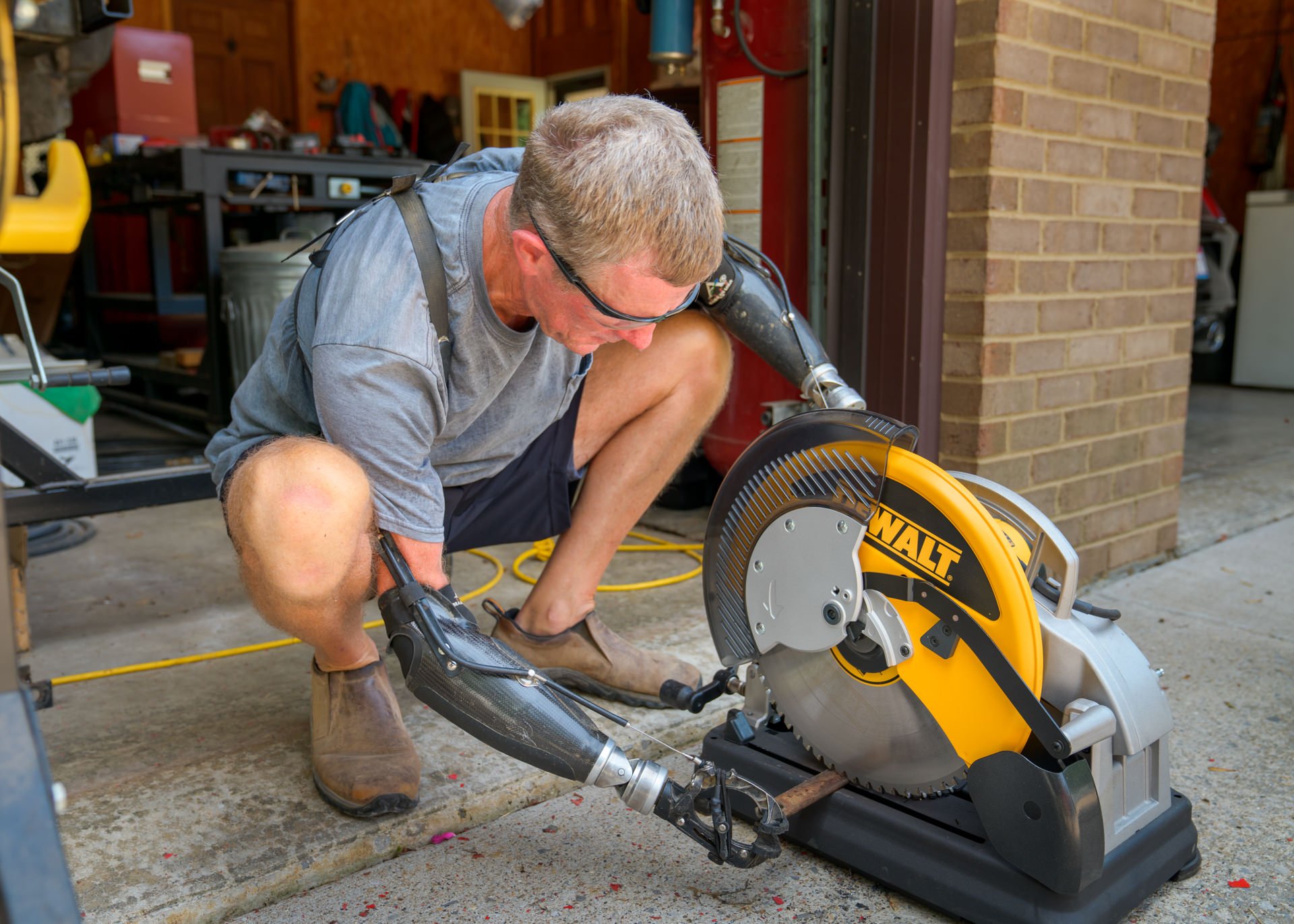 Gerry Kinney, a bilateral transradial patient, wears his body-powered prostheses to get work done around the shop.