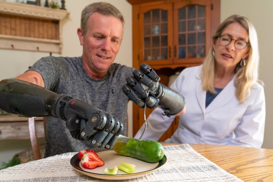 Therapist training patient how to use TASKA hands to eat
