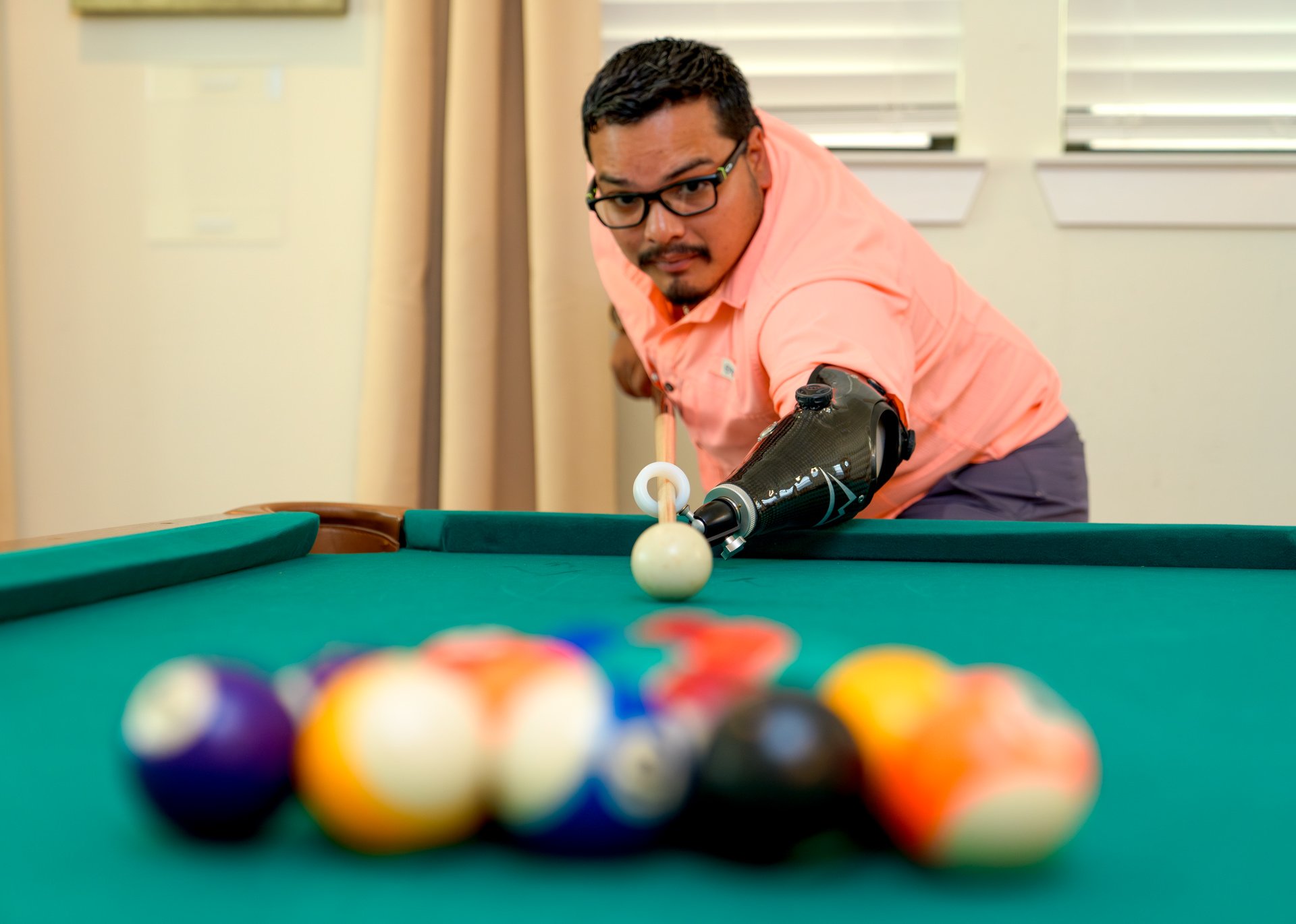 A transradial patient, Ricardo Gasca, uses his activity-specific pool prosthesis.