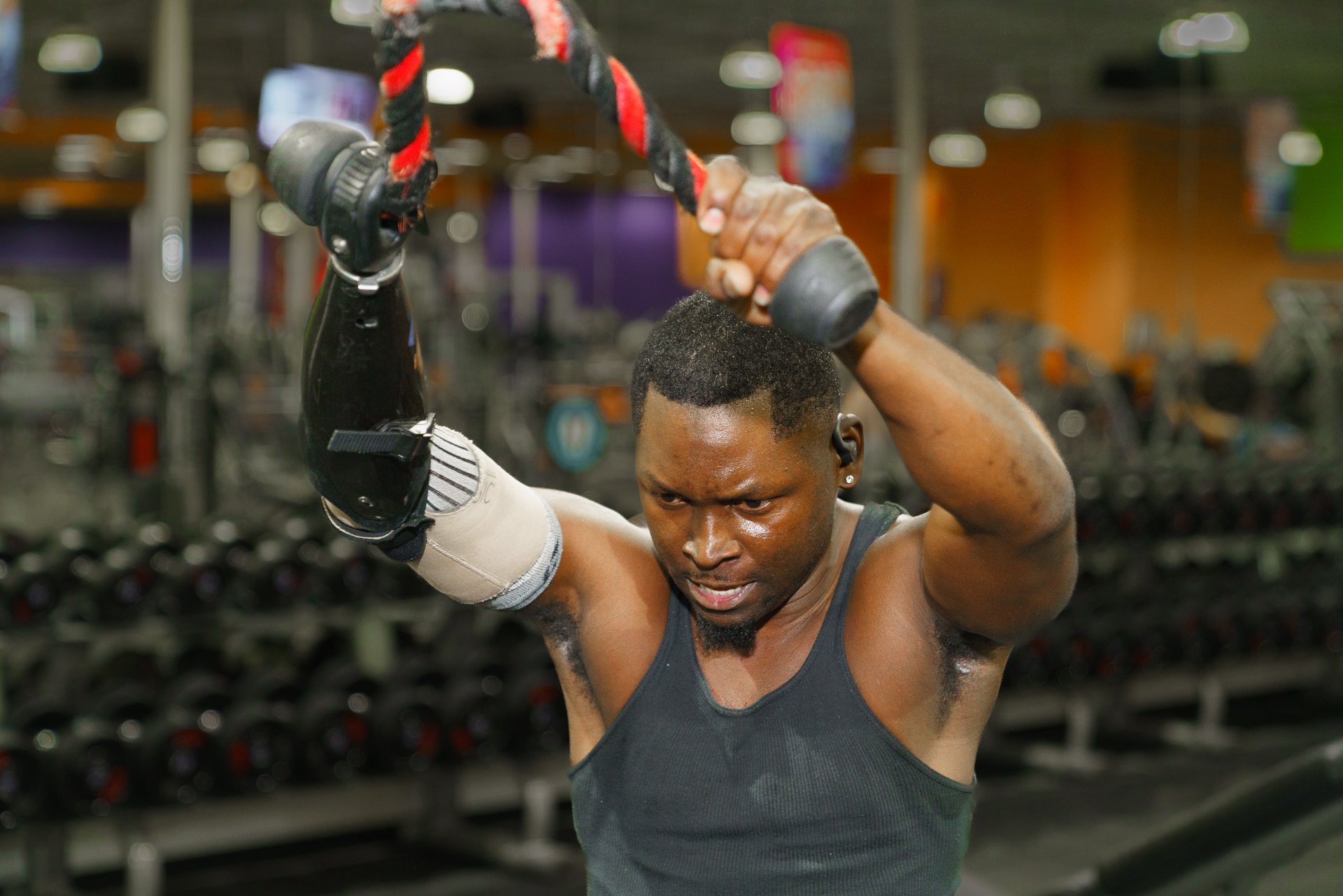 Xavier Collier, a transradial amputee, uses his workout activity-specific prosthesis at the gym.