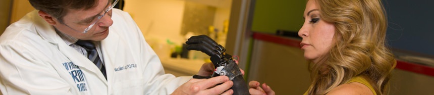 Candice Dicke working with prosthetist Mac Lang on her partial hand prosthesis with i-limb digits