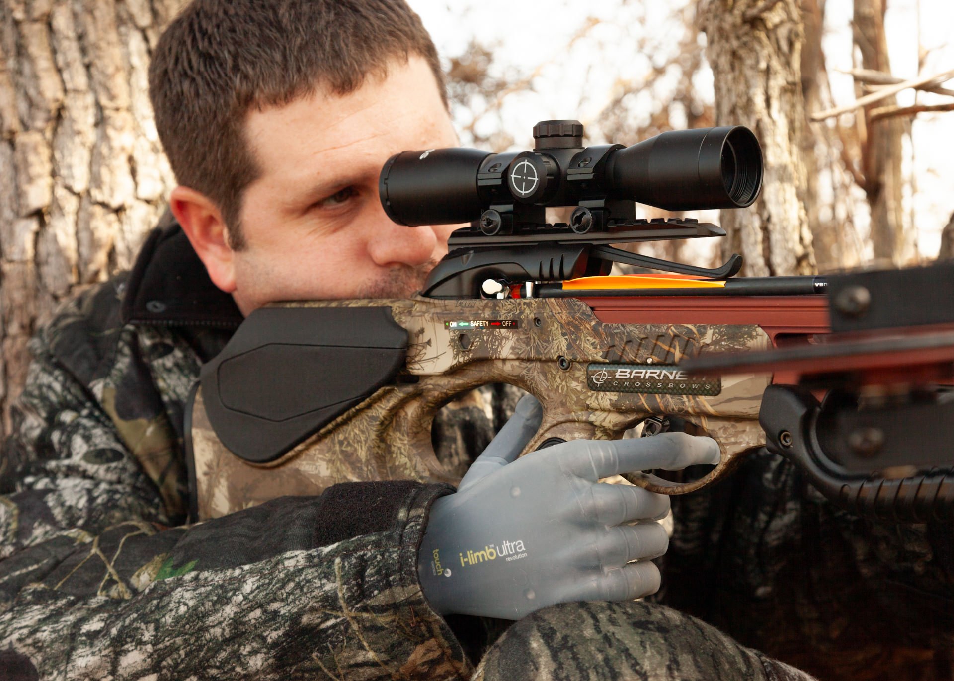 Jason Koger, a bilateral transradial patient, uses his myoelectric hand to trigger a bow.