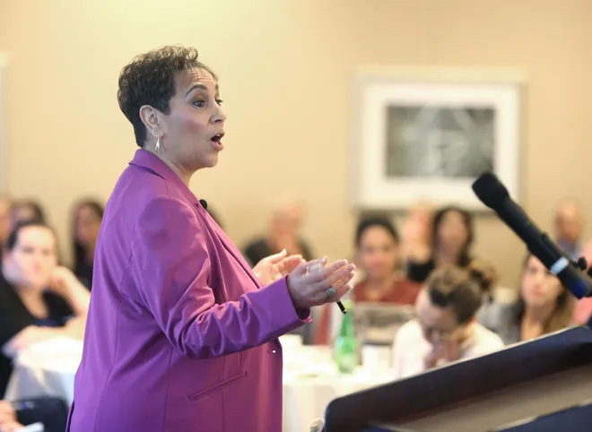 Merlyna speaks at a conference