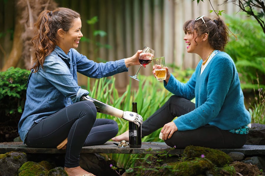 Portland Center Patient Shaholly Ayers enjoys a toast with her friend using her Myoelectruic Hand-1
