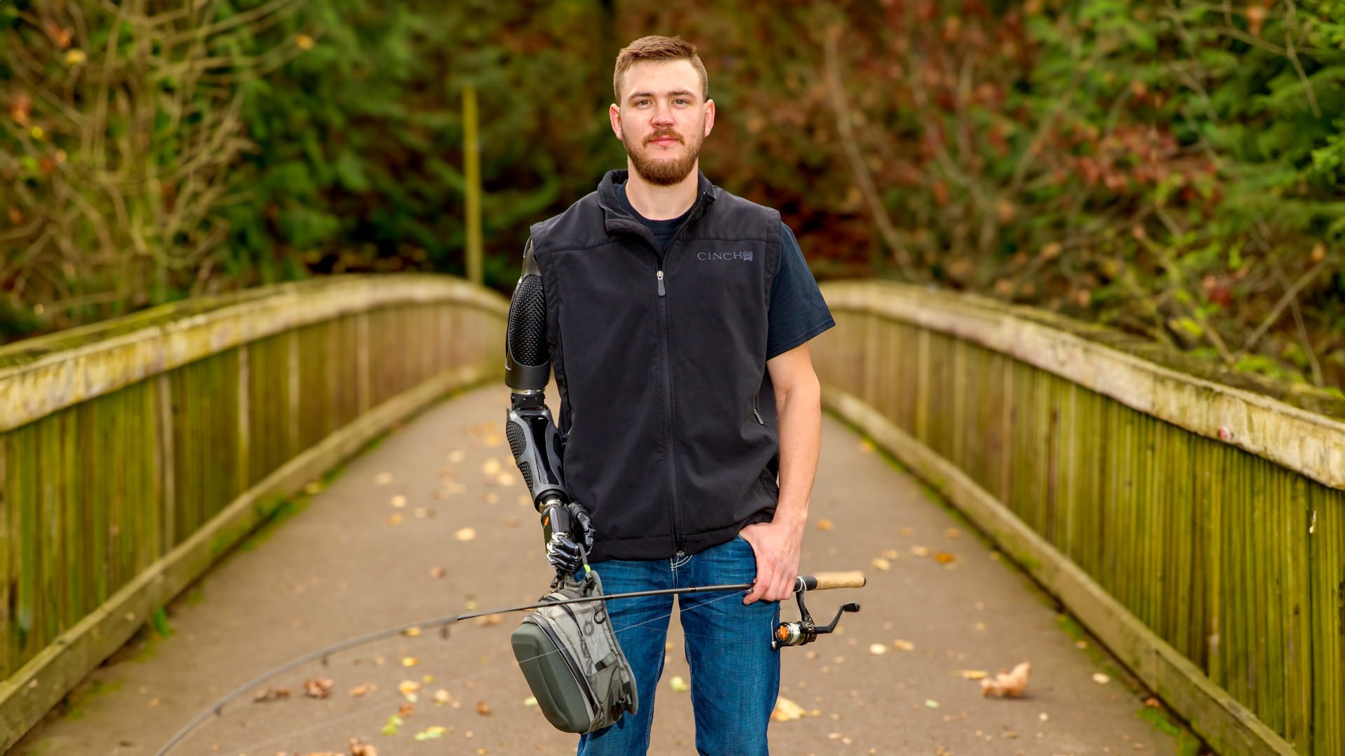 Sam Rosecrans fishing with his shoulder level myoelectric prosthesis in Portland