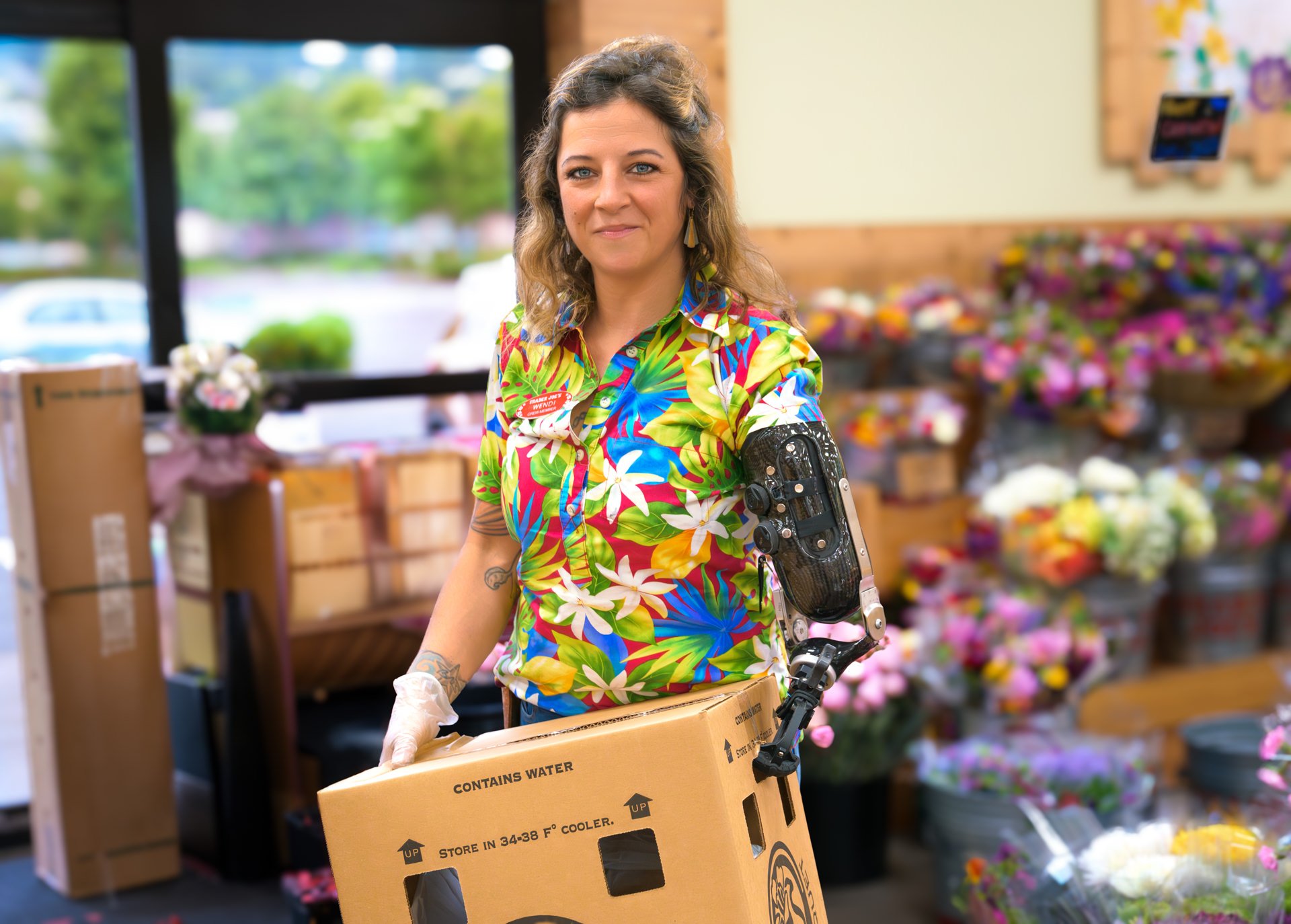 Wendi Parker Working at Trader Joe's with her custom transhumeral prosthesis
