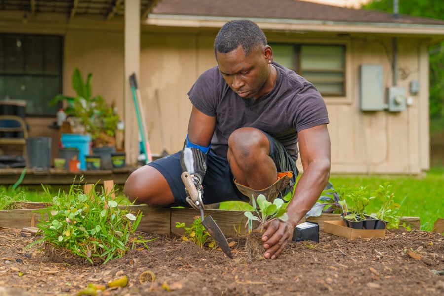 Amputee working in his garden with an ETD prosthesis