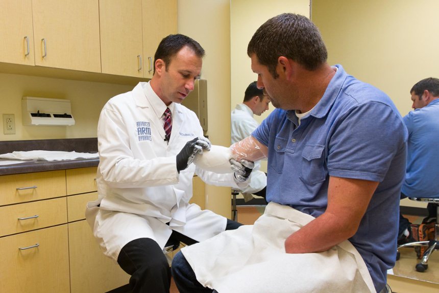Prosthetist Rob Dodson takes a mold of Bilateral Amputee Jason Koger's residual limb