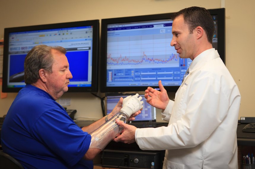 Prosthetist Rob Dodson checks alignment of the prosthesis