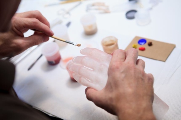 Arm Dynamics artist painting a custom silicone restoration prosthesis