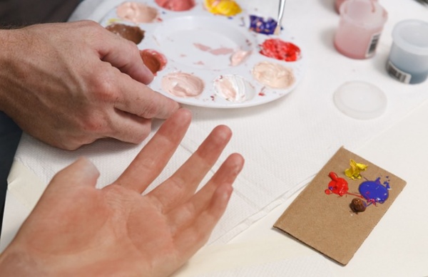 Arm Dynamics artist matching skin tone on a custom silicone restoration prosthesis