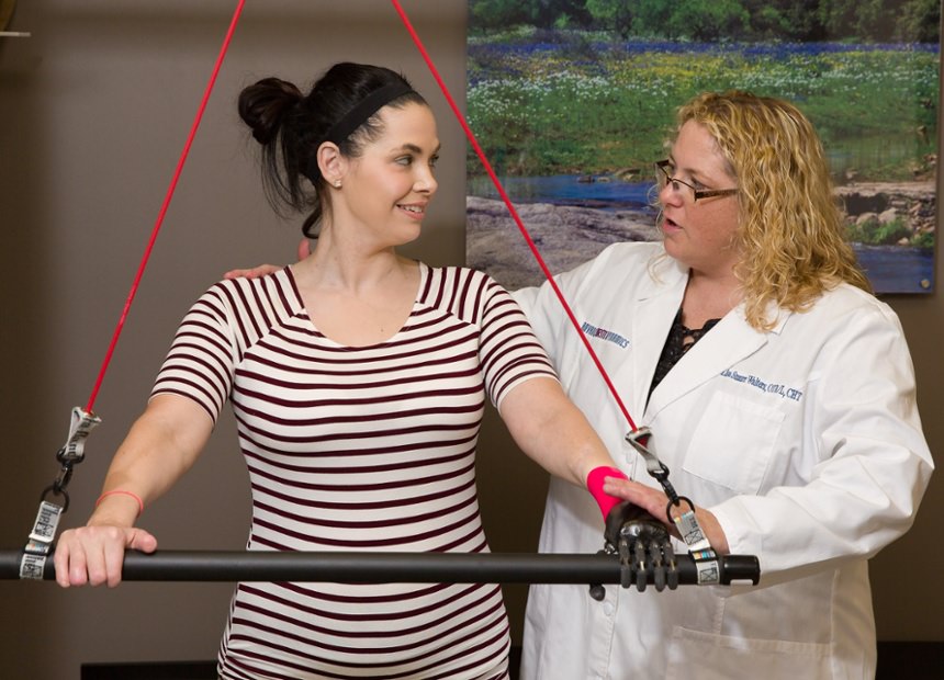 Arm Dynamics occupational therapist instruction patient how to properly use her multi-positional joints prosthesis